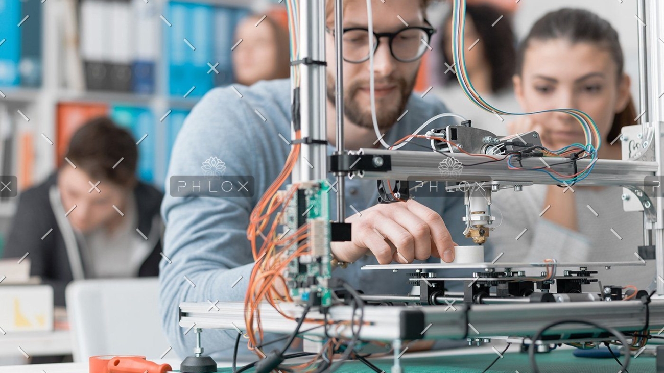 demo-attachment-61-students-using-a-3d-printer-PJKMSXD